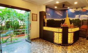 a lobby with a bar with a view of a resort at Hotel Saideep Villas, Shirdi in Shirdi