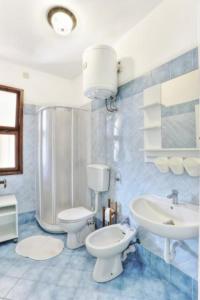 a bathroom with a white toilet and a sink at Capoliveri: Villa Artistica app. 2/bilo4 (bilocale in Capoliveri