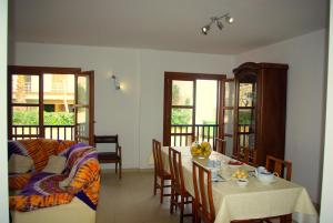 a living room with a table and a couch at Na Margarida in S'Illot