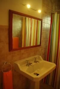 a bathroom with a sink and a mirror at Na Margarida in S'Illot