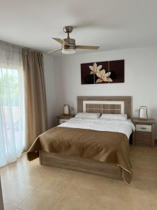 a bedroom with a bed and a ceiling fan at Apartment in Mar Menor Golf Resort in Torre-Pacheco