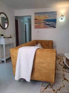 a couch with a blanket on it in a living room at Stellar 1-bedroom apartment in Madaraka Estate, Nairobi in Nairobi