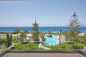 a view of the ocean from the balcony of a resort at Sheraton Rhodes Resort in Ixia