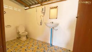 a bathroom with a sink and a toilet at Sun Moon Pai Bungalow in Pai