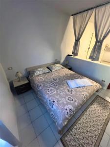 Katil atau katil-katil dalam bilik di Appartamento Civico 23