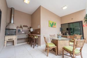 a kitchen with a counter and a table and chairs at Class Hotel Alfenas in Alfenas