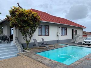 a house with a swimming pool in front of it at TSGuesthouse in Margate