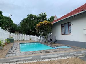 a swimming pool in the backyard of a house at TSGuesthouse in Margate