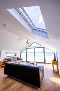 a bedroom with a large skylight in a loft at The Coach House in Alnwick