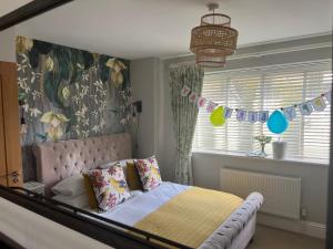 a bedroom with a bed and a window with flags at Isabella's Yard in Stamford