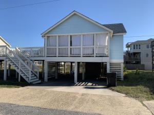 a house with a large porch with a deck at Calico Jack's Galley cottage in Kitty Hawk
