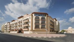 a large building on the side of a street at Arabian Dreams Hotel Apartments in Dubai