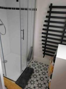 a bathroom with a glass door and a tiled floor at The Loft in Crossmolina