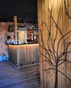 a wooden wall with a bar in a restaurant at Hotell Temperance in Hudiksvall