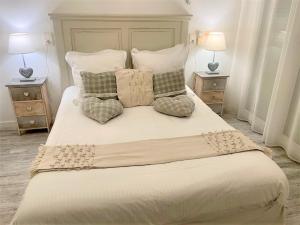 a bedroom with a large bed with two night stands at Hôtel Le Méditerranée in Hyères