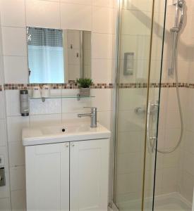a bathroom with a sink and a shower at Hôtel Le Méditerranée in Hyères