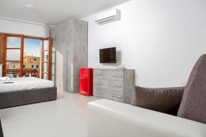 um quarto com uma cama e um frigorífico vermelho em Romeo and Juliet Affittacamere em Santa Teresa Gallura