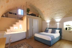 a bedroom with a bed and stairs in a room at Maison Chene con vasca idromassaggio in Bisceglie