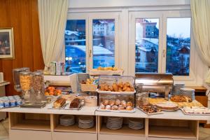 a table filled with lots of different types of food at Hotel Andalo in Andalo