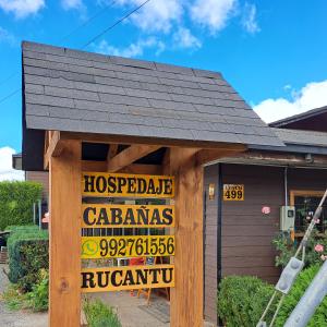 ein Haus mit einem Schild auf der Vorderseite in der Unterkunft Hosteria y Cabañas Rucantu in Freire