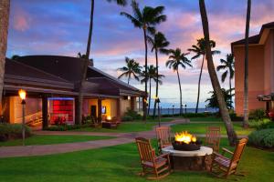 a fire pit in a yard in front of a house at Sheraton Kauai Resort in Koloa