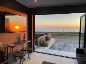 a living room with a view of the ocean at Seaview Stay in Peacehaven