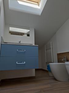 a bathroom with a blue dresser and a sink at Attico al Gallitello in Potenza +32 photos