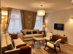 a living room with a couch and a tv at Brand new flat heart of Vilnius in Vilnius