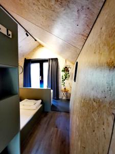 a small room with a bed and a window at Diamond Suite in the woods in Holten