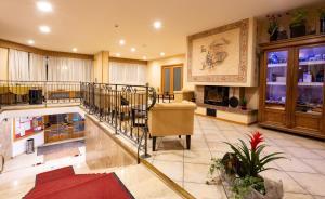 a large lobby with a staircase in a building at Hotel Andalo in Andalo