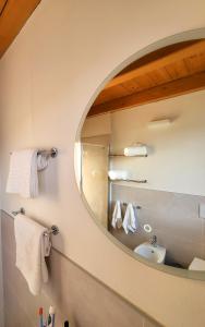 a bathroom with a mirror and a sink at Sol Lakeview in Sale Marasino
