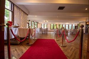 a red carpet in a banquet hall with a red rope at McArthur Manor in Blairgowrie