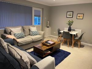 a living room with a couch and a table at Lovely flat set in parish boundary of Instow in Instow