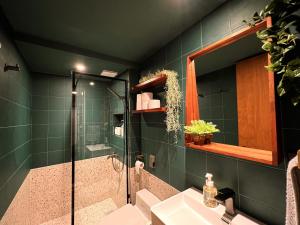 a bathroom with a shower and a sink and a mirror at HHZib, homestay on a hill in the heart of Seoul in Seoul