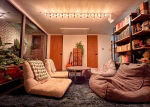 a living room with two couches and a table at HHZib, homestay on a hill in the heart of Seoul in Seoul