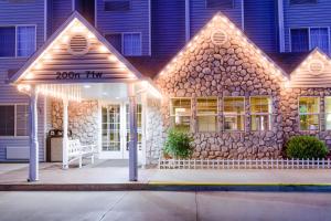 a house with a inn lit up at night at River Canyon Lodge in Moab