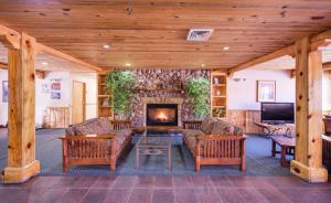 a living room with a fireplace in a house at River Canyon Lodge in Moab