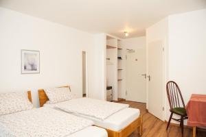 a bedroom with two beds and a table and a chair at Landgasthof Witten in Labenz
