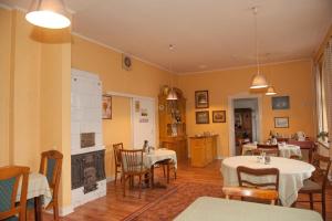 a dining room with two tables and a fireplace at Landgasthof Witten in Labenz