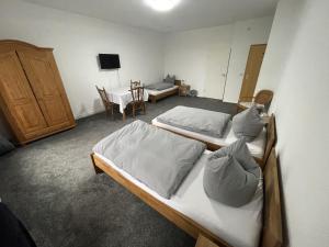 a bedroom with two beds and a desk and a table at Landgasthof Witten in Labenz