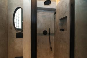 a shower with a glass door in a bathroom at Brescia musei in Brescia