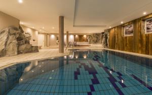 a large swimming pool in a hotel with a swimming pool at Bed & Breakfast ABIS - Dolomites in Valles