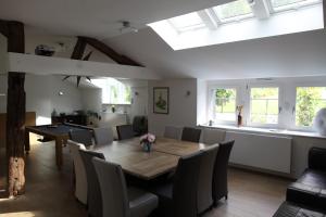 a dining room with a table and chairs at Gîte LES ARMINAUX in Remilly-les-Pothées