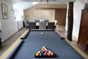 a pool table with balls in a living room at Gîte LES ARMINAUX in Remilly-les-Pothées