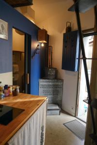 a kitchen with a wooden counter top and blue walls at Surprenantes - Voyage en Ballon in Nantes