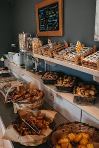 a bakery with shelves filled with different types of pastries at Paros Bay in Parasporos