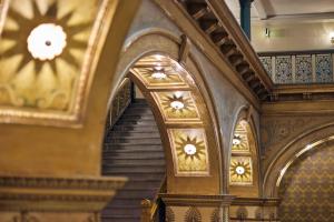 a staircase in a building with ornate ceilings and stairs at The Brown Palace Hotel and Spa, Autograph Collection in Denver