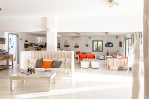 a living room with a couch and a table at Paros Bay in Parasporos