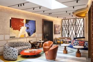 a lobby with couches and chairs and tables at W Rome in Rome