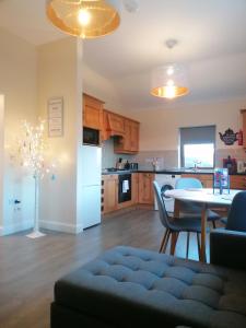 a living room with a table and a kitchen at Atlantic way Apartment in Sligo